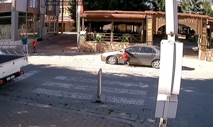 Yaya geçidinden karşıya geçmek isteyen çocuk, otomobilin altında kalmaktan son anda kurtuldu