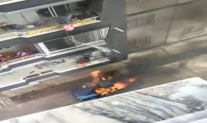 Yanan araca, balkondan kova ile su dökerek müdahale etti